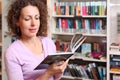 Woman reads book in room