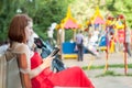 Woman reads e-book against playground area Royalty Free Stock Photo