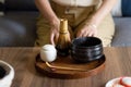 Woman ready for making matcha green tea drink at home using tea ceremony set Royalty Free Stock Photo