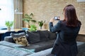 Woman real estate agent photographing furnished apartment Royalty Free Stock Photo