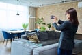 Woman real estate agent photographing furnished apartment Royalty Free Stock Photo