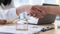 Woman real estate agents or house seller and customers shake hand