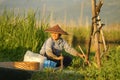 Woman reaping a harvest in floating garden on Inle lake