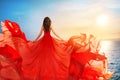 Woman Rear view in Red Flying Dress Fluttering on Wind, Girl in Waving Gown on Sea