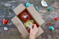 A woman received a parcel with broken Christmas tree glass balls. The concept of a bad packing of goods Royalty Free Stock Photo