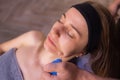 Woman receives facial cupping massage facial rejuvenation at acupuncture wellness spa.