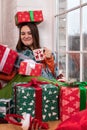 The woman receives a New Year`s gift in a box and laughs. Gifts for Christmas and New Year 2021 Royalty Free Stock Photo