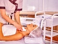 Woman receiving electric facial peeling massage.