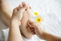 Woman receiving foot massage service from masseuse close up at hand and foot