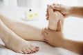 Woman receiving foot massage service from masseuse close up at hand and foot Royalty Free Stock Photo