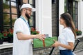 Woman receiving gift boxes from courier. Royalty Free Stock Photo