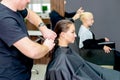 Woman receiving haircut by hairdresser Royalty Free Stock Photo