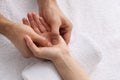 Woman receiving hand massage on soft towel, above view Royalty Free Stock Photo