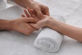 Woman receiving hand massage on soft towel, closeup Royalty Free Stock Photo