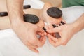 Hot stone massage on feet Royalty Free Stock Photo