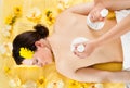 Woman receiving massage with herbal compress balls at spa Royalty Free Stock Photo