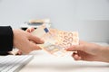 Woman receiving money from teller at cash department window Royalty Free Stock Photo