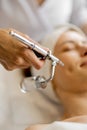 Woman receiving oxygen mesotherapy on her face,