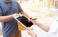 Woman receiving package from delivery man Royalty Free Stock Photo