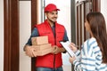 Woman receiving parcels from delivery service courier