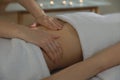 Woman receiving professional belly massage in wellness center, closeup Royalty Free Stock Photo