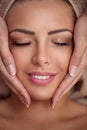 Woman receiving professional face massage