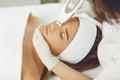 Woman receiving ultrasound apparatus facial cleaning in beauty salon Royalty Free Stock Photo