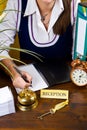 Woman at the reception of a hotel checking in