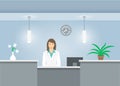 Woman receptionist in medical coat at reception desk in hospital Royalty Free Stock Photo