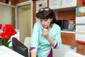 Woman receptionist in veterinary clinic talking on phone with customer Royalty Free Stock Photo