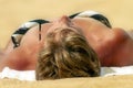 Woman Reclining Sun Tanning on a Tropical Beach