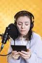 Woman recording audiobook, reading text from tablet, portraying characters Royalty Free Stock Photo