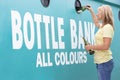 Woman At Recycling Centre At Bottle Bank Royalty Free Stock Photo