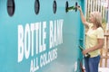 Woman At Recycling Centre At Bottle Bank Royalty Free Stock Photo