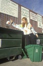 A woman recycling plastics