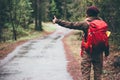 Woman with red backpack hitchhiking alone Royalty Free Stock Photo