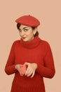 Woman in red with beret holding a gift Royalty Free Stock Photo