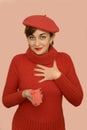 Woman in red with beret holding a gift Royalty Free Stock Photo