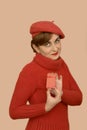 Woman in red with beret holding a gift Royalty Free Stock Photo