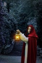 Woman with red cape and lantern Royalty Free Stock Photo