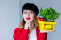 Woman in red cardigan and hat with herbs and tomatoes in yellow Royalty Free Stock Photo