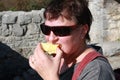 A woman with red cheeks in forest having break with snack Royalty Free Stock Photo