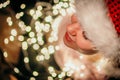 Woman in red christmas hat on led lights bokeh background. New year concept Royalty Free Stock Photo