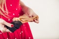 Woman in red dott dress holding tan vintage stockings Royalty Free Stock Photo