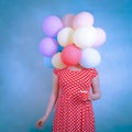 Woman in a red dotty dress holding matching coffee mug