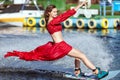 Woman in a red dress does not wakeboard. Royalty Free Stock Photo