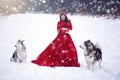 Woman on red dress with dogs