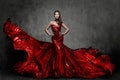 Woman Red Dress, Fashion Model in Long Silk Gown Waving Cloth on Wind, Flying Fluttering Fabric Royalty Free Stock Photo