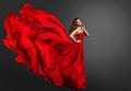 Woman Red Dress, Fashion Model in Long Silk Gown Waving on Wind, Fantasy Girl in Flying Fabric. Black Background Royalty Free Stock Photo