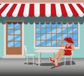 woman in a red dress and hat sits on a chair in a summer cafe Royalty Free Stock Photo